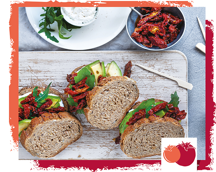 Sandwich with avocado, dried tomato strips and creamy goat cheese